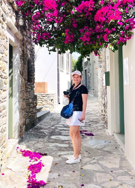 Deb Morrow in Halki Village, Naxos under a pink bougainvillea